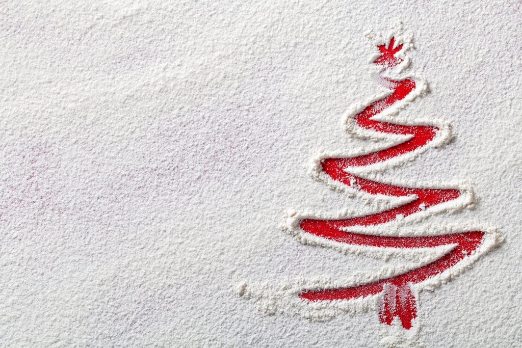 Christmas tree on flour background. White flour looks like snow. Top view